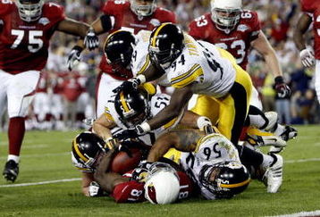 TAMPA, FL - FEBRUARY 01:   Aaron Smith #91, James Farrior #51, Brett Keisel #99, Lawrence Timmons #94 and LaMarr Woodley #56 of the Pittsburgh Steelers tackle Wide receiver Anquan Boldin #81 of the Arizona Cardinals before the goalline on a 45-yard reception by Boldin during the second quarter of Super Bowl XLIII on February 1, 2009 at Raymond James Stadium in Tampa, Florida.  (Photo by Streeter Lecka/Getty Images)