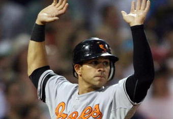 BOSTON - JUNE 10:  Brian Roberts #1 of the Baltimore Orioles scores a run as he crosses the plate in the seventh inning against the Boston Red Sox at Fenway Park June 10, 2008 in Boston, Massachusetts.  (Photo by Elsa/Getty Images)