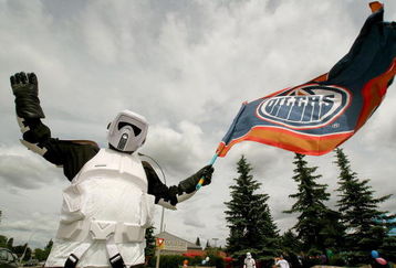 EDMONTON, AB - JUNE 17:  David Kho a fan of the Edmonton Oilers dressed as a 'Star Wars' Stormtrooper on I75 flies an Oilers flag before game six of the 2006 NHL Stanley Cup Finals against the Carolina Hurricanes on June 17, 2006 at Rexall Place in Edmonton, Alberta, Canada.   (Photo by Tim Smith/Getty Images)