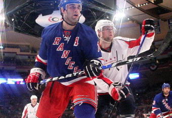 NEW YORK - APRIL 26: Scott Gomez #19 of the New York Rangers skates against Mike Green #52 of the Washington Capitals during Game Six of the Eastern Conference Quarterfinal Round of the 2009 NHL Stanley Cup Playoffs at Madison Square Garden on April 26, 2009 in New York, New York.  (Photo by Bruce Bennett/Getty Images)