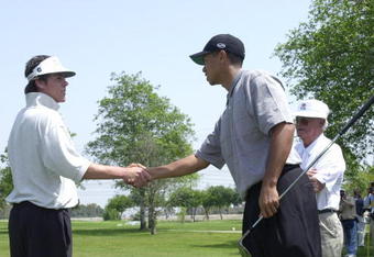 387831 20: Professional golfer Tiger Woods greets 16-year-old junior golfer L.C. Honore April 14, 2001 at the Coca-Cola Tiger Woods Foundation Junior Golf Clinic at the El Dorado Park Golf Course in Long Beach, CA. (Photo by Chris Weeks/Liaison)