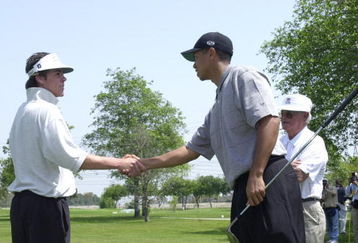 387831 20: Professional golfer Tiger Woods greets 16-year-old junior golfer L.C. Honore April 14, 2001 at the Coca-Cola Tiger Woods Foundation Junior Golf Clinic at the El Dorado Park Golf Course in Long Beach, CA. (Photo by Chris Weeks/Liaison)