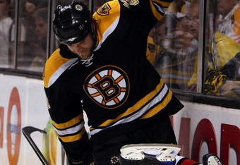 BOSTON - MAY 14:  Erik Cole #26 of the Carolina Hurricanes Steve Montador #23 of the Boston Bruins are tangled up during Game Seven of the Eastern Conference Semifinal Round of the 2009 Stanley Cup Playoffs on May 14, 2009 at the TD Banknorth Garden in Boston, Massachusetts. The Hurricanes defeated the Bruins 3-2 in overtime. (Photo by Elsa/Getty Images)
