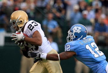 CHAPEL HILL, NC - OCTOBER 11:  Golden Tate #23 of the Notre Dame Fighting Irish catches a pass in front of Charles Brown #12 of the North Carolina Tar Heels during the first half of their game at Kenan Stadiium on October 11, 2008 in Chapel Hill, North Carolina. (Photo by Scott Halleran/Getty Images)