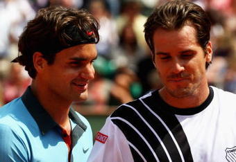 PARIS - JUNE 01:  Roger Federer (L) of Switzerland chats with Tommy Haas of Germany following his victory during the Men's Singles Fourth Round match on day nine of the French Open at Roland Garros on June 1, 2009 in Paris, France.  (Photo by Clive Brunskill/Getty Images)