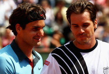PARIS - JUNE 01:  Roger Federer (L) of Switzerland chats with Tommy Haas of Germany following his victory during the Men's Singles Fourth Round match on day nine of the French Open at Roland Garros on June 1, 2009 in Paris, France.  (Photo by Clive Brunskill/Getty Images)