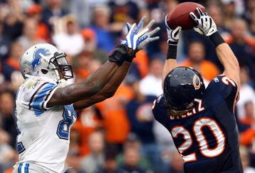 CHICAGO - NOVEMBER 02:  Craig Steltz #20 of the Chicago Bears intercepts a pass intended for Calvin Johnson #81 of the Detroit Lions during the fourth quarter at Soldier Field on November 2, 2008 in Chicago, Illinois. The Bears defeated the Lions 27-23.  (Photo by Jeff Gross/Getty Images)