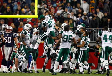 FOXBORO, MA - NOVEMBER 13:  Kerry Rhodes #25 jumps on Jay Feely #3 of the New York Jets after Feely kicked  the game-winning field goal in overtime against the New England Patriots at Gillette Stadium on November 13, 2008 in Foxboro, Massachusetts. The Jets won 34-31 in overtime. (Photo by Jim Rogash/Getty Images)