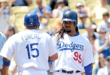 LOS ANGELES, CA - APRIL 19:  Rafael Furcal #15 of the Los Angeles Dodgers scores a run in front of Manny Ramirez #99 against the Colorado Rockies for a 1-0 lead during the first inning at Dodger Stadium on April 19, 2009 in Los Angeles, California.  (Photo by Harry How/Getty Images)
