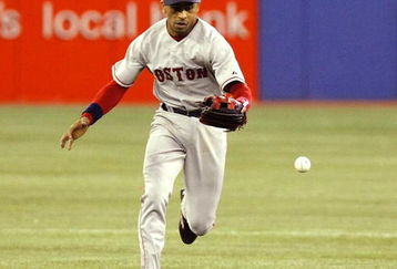TORONTO - APRIL 6:  Julio Lugo #23 of the Boston Red Sox bobbles a catch against the Toronto Blue Jays and is charged with an error during their MLB game at the Rogers Centre April 6, 2008 in Toronto, Canada. (Photo by Dave Sandford/Getty Images)