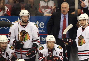 DETROIT - MAY 27:  (L-R) Patrick Sharp #10, Troy Brouwer #22, Kris Versteeg #32, head coach Joel Quenneville and Dave Bolland #36 of the Chicago Blackhawks look on from the bench dejected late in the game against the Detroit Red Wings during Game Five of the Western Conference Championship Round of the 2009 Stanley Cup Playoffs on May 27, 2009 at Joe Louis Arena in Detroit, Michigan.  (Photo by Claus Andersen/Getty Images)