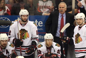 DETROIT - MAY 27:  (L-R) Patrick Sharp #10, Troy Brouwer #22, Kris Versteeg #32, head coach Joel Quenneville and Dave Bolland #36 of the Chicago Blackhawks look on from the bench dejected late in the game against the Detroit Red Wings during Game Five of the Western Conference Championship Round of the 2009 Stanley Cup Playoffs on May 27, 2009 at Joe Louis Arena in Detroit, Michigan.  (Photo by Claus Andersen/Getty Images)