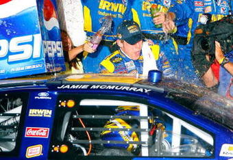 DAYTONA, FL - JULY 07: Jamie McMurray, driver of the #26 IRWIN Marathon Tools Ford, gets out of his car to celebrate with his crew members on victory lane after winning the NASCAR Nextel Cup Series Pepsi 400 at Daytona International Speedway on July 7, 2007 in Daytona, Florida.   (Photo by Rusty Jarrett/Getty Images for NASCAR)