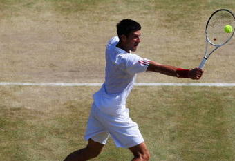 WIMBLEDON, ENGLAND - JULY 01:  Novak Djokovic of Serbia plays backhand during the men's singles quarter final match against Tommy Haas of Germany on Day Nine of the Wimbledon Lawn Tennis Championships at the All England Lawn Tennis and Croquet Club on July 1, 2009 in London, England.  (Photo by Hamish Blair/Getty Images)