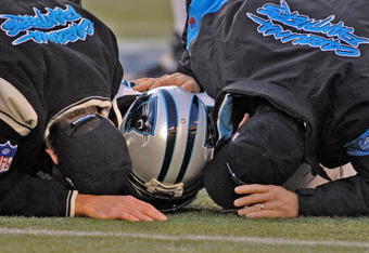 Carolina Panthers trainers examine running back Nick Goings during an injury timeout at  an NFC wildcard game January 8, 2006 at the Meadowlands.  The Carolina Panthers defeated the Giants 23 - 0.  (Photo by Al Messerschmidt/Getty Images)