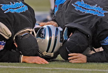 Carolina Panthers trainers examine running back Nick Goings during an injury timeout at  an NFC wildcard game January 8, 2006 at the Meadowlands.  The Carolina Panthers defeated the Giants 23 - 0.  (Photo by Al Messerschmidt/Getty Images)