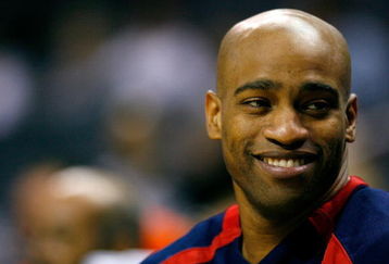 CHARLOTTE, NC - OCTOBER 15:  Vince Carter #15 of the New Jersey Nets enjoys a laugh on the bench late in the second half during their 96-86 preseason loss to the Charlotte Bobcats at Charlotte Bobcats Arena October 15, 2007 in Charlotte, North Carolina. Charlotte defeated New Jersey 96-86.  (Photo by Kevin C. Cox/Getty Images)