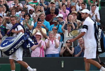 WIMBLEDON, ENGLAND - JULY 01:  Lleyton Hewitt of Australia (L) leaves court alongside Andy Roddick of USA after the men's singles quarter final match Championships at the All England Lawn Tennis and Croquet Club on July 1, 2009 in London, England.  (Photo by Hamish Blair/Getty Images)