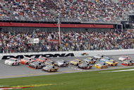 DAYTONA BEACH, FL - FEBRUARY 15:  David Ragan, driver of the #6 UPS Ford races Denny Hamlin, driver of the #11 FedEx Express Toyota, and Joey Logano, driver of the #20 Home Depot Toyota, during the NASCAR Sprint Cup Series Daytona 500 at Daytona International Speedway on February 15, 2009 in Daytona Beach, Florida.  (Photo by Geoff Burke/Getty Images for NASCAR)