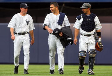 NEW YORK - JULY 01:  Pitcher Andy Pettitte #46 (C) of the New York Yankees walks in from the bullpen to start the game against the Seattle Mariners with teammate Jorge Posada #20 and pitching coach Dave Eiland on July 1, 2009 at Yankee Stadium in the Bronx borough of New York City.  (Photo by Jim McIsaac/Getty Images)