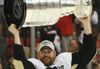 DETROIT - JUNE 12: Hal Gill #2 of the Pittsburgh Penguins holds the Stanley Cup following the Penguins victory over the Detroit Red Wings in Game Seven of the 2009 NHL Stanley Cup Finals at Joe Louis Arena on June 12, 2009 in Detroit, Michigan. (Photo by Bruce Bennett/Getty Images)