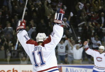 BOSTON, MA - APRIL 23:  Saku Koivu #11 of the Montreal Canadiens celebrates after assisting on Yanic Perreault's goal against the Boston Bruins during game three of the Stanley Cup playpoffs at the Molson Center in Montreal, Canada on April 23, 2002. The Canadiens won 5-3. (Photo by Jeff Gross/Getty Images/NHLI)  