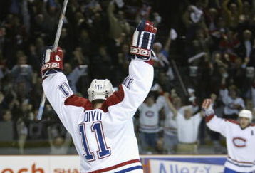 BOSTON, MA - APRIL 23:  Saku Koivu #11 of the Montreal Canadiens celebrates after assisting on Yanic Perreault's goal against the Boston Bruins during game three of the Stanley Cup playpoffs at the Molson Center in Montreal, Canada on April 23, 2002. The Canadiens won 5-3. (Photo by Jeff Gross/Getty Images/NHLI)  