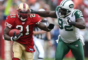 SAN FRANCISCO - DECEMBER 07:  Frank Gore #21 of the San Francisco 49ers runs against Shaun Ellis #92 of the New York Jets during an NFL game on December 7, 2008 at Candlestick Park in San Francisco, California.  (Photo by Jed Jacobsohn/Getty Images)