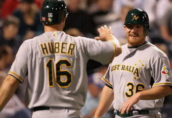 PEORIA, AZ - MARCH 04:  Ben Risinger #36 of Team Australia is congratulated by Justin Huber #16 after Risinger scored a run against the Seattle Mariners during the spring training game at Peoria Stadium on March 4, 2009 in Peoria, Arizona.  (Photo by Christian Petersen/Getty Images)