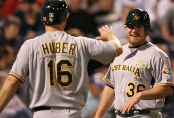 PEORIA, AZ - MARCH 04:  Ben Risinger #36 of Team Australia is congratulated by Justin Huber #16 after Risinger scored a run against the Seattle Mariners during the spring training game at Peoria Stadium on March 4, 2009 in Peoria, Arizona.  (Photo by Christian Petersen/Getty Images)