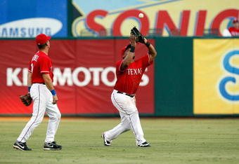 ARLINGTON, TX - JULY 1:  Center fielder Marlon Byrd #22 of the Texas Rangers makes the fly out against Juan Rivera #20 of the Los Angeles Angels of Anaheim (not pictured) at Rangers Ballpark July 1, 2009 in Arlington, Texas.  (Photo by Ronald Martinez/Getty Images)