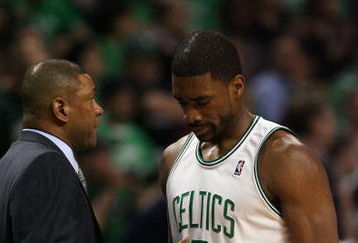 BOSTON - APRIL 18:  Head coach Doc Rivers of the Boston Celtics consoles Leon Powe #0 in the second half against the Chicago Bulls in Game One of the Eastern Conference Quarterfinals during the 2009 NBA Playoffs at TD Banknorth Garden on April 18, 2009 in Boston, Massachusetts. The Chicago Bulls defeated the Boston Celtics 105-103 in overtime. NOTE TO USER: User expressly acknowledges and agrees that, by downloading and or using this photograph, User is consenting to the terms and conditions of the Getty Images License Agreement. (Photo by Elsa/Getty Images)