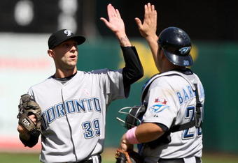OAKLAND, CA - MAY 10: Jesse Carlson #39 of the Toronto Blue Jays celebrates with Rod Barajas #20 after defeating the Oakland Athletics during a Major League Baseball game on May 10, 2009 at the Oakland Coliseum in Oakland, California. (Photo by Jed Jacobsohn/Getty Images)