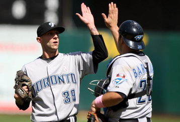 OAKLAND, CA - MAY 10: Jesse Carlson #39 of the Toronto Blue Jays celebrates with Rod Barajas #20 after defeating the Oakland Athletics during a Major League Baseball game on May 10, 2009 at the Oakland Coliseum in Oakland, California. (Photo by Jed Jacobsohn/Getty Images)
