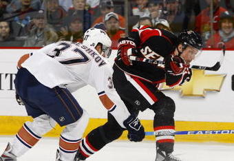 OTTAWA - MARCH 5:  Dennis Grebeshkov #37 of the Edmonton Oilers tries to deflect a shot by Dany Heatley #15 of the Ottawa Senators during a game on March 5, 2009 at the Scotiabank Place in Ottawa, Canada. (Photo by Phillip MacCallum/Getty Images)