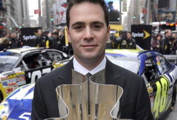 NEW YORK - NOVEMBER 29:  Jimmie Johnson, the 2007 NASCAR Nextel Cup Champion, poses with the NASCAR Nextel Cup Trophy in Times Square during NASCAR Champions Week November 29, 2007 in New York City.  (Photo by Chris Trotman/Getty Images for NASCAR)