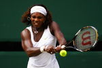 WIMBLEDON, ENGLAND - JULY 02:  Serena Williams of USA plays a backhand during the women's singles semi final match against Elena Dementieva of Russia on Day Ten of the Wimbledon Lawn Tennis Championships at the All England Lawn Tennis and Croquet Club on July 2, 2009 in London, England.  (Photo by Julian Finney/Getty Images)