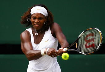WIMBLEDON, ENGLAND - JULY 02:  Serena Williams of USA plays a backhand during the women's singles semi final match against Elena Dementieva of Russia on Day Ten of the Wimbledon Lawn Tennis Championships at the All England Lawn Tennis and Croquet Club on July 2, 2009 in London, England.  (Photo by Julian Finney/Getty Images)