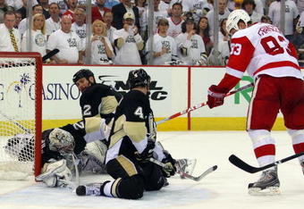 PITTSBURGH - JUNE 09:  Johan Franzen #93 of the Detroit Red Wings has his shot blocked by Rob Scuderi #4 of the Pittsburgh Penguins late in Game Six of the NHL Stanley Cup Finals at the Mellon Arena on June 9, 2009 in Pittsburgh, Pennsylvania.  (Photo by Jim McIsaac/Getty Images)