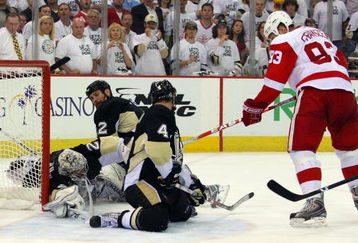 PITTSBURGH - JUNE 09:  Johan Franzen #93 of the Detroit Red Wings has his shot blocked by Rob Scuderi #4 of the Pittsburgh Penguins late in Game Six of the NHL Stanley Cup Finals at the Mellon Arena on June 9, 2009 in Pittsburgh, Pennsylvania.  (Photo by Jim McIsaac/Getty Images)