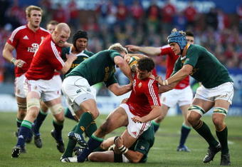PRETORIA, SOUTH AFRICA - JUNE 27:  South Africa defence stop Jamie Roberts of the Lions from breaking through during the Second Test match between South Africa and the British and Irish Lions at Loftus Versfeld on June 27, 2009 in Pretoria, South Africa.  (Photo by David Rogers/Getty Images)