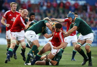 PRETORIA, SOUTH AFRICA - JUNE 27:  South Africa defence stop Jamie Roberts of the Lions from breaking through during the Second Test match between South Africa and the British and Irish Lions at Loftus Versfeld on June 27, 2009 in Pretoria, South Africa.  (Photo by David Rogers/Getty Images)
