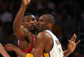 LOS ANGELES, CA - MAY 17:  Kobe Bryant #24 of the Los Angeles Lakers is covered by Ron Artest #96 of the Houston Rockets in the third quarter of Game Seven of the Western Conference Semifinals during the 2009 NBA Playoffs at Staples Center on May 17, 2009 in Los Angeles, California. NOTE TO USER: User expressly acknowledges and agrees that, by downloading and or using this photograph, User is consenting to the terms and conditions of the Getty Images License Agreement.  (Photo by Stephen Dunn/Getty Images)
