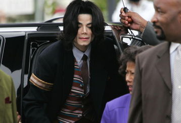 SANTA MARIA, CA - MAY 26:  Singer Michael Jackson emerges from his sport utility vehicle as he arrives at the Santa Barbara County Courthouse for his child molestation trial May 26, 2005 in Santa Maria, California. Jackson is charged in a 10-count indictment with molesting a boy, plying him with liquor and conspiring to commit child abduction, false imprisonment and extortion.  (Photo by Hector Mata-Pool/Getty Images)