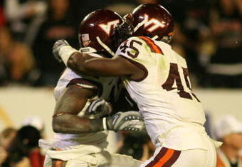 MIAMI - JANUARY 01:   Kam Chancellor #17 celabrates an interception with Purnell Sturdivant #45 of the Virginia Tech Hokies against  the Cincinnati Bearcats  during the FedEx Orange Bowl at Dolphin Stadium on January 1, 2009 in Miami, Florida.  (Photo by Marc Serota/Getty Images)