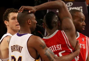 LOS ANGELES, CA - MAY 17:  Kobe Bryant #24 of the Los Angeles Lakers and Ron Artest #96 of the Houston Rockets get twisted up in the second quarter of Game Seven of the Western Conference Semifinals during the 2009 NBA Playoffs at Staples Center on May 17, 2009 in Los Angeles, California. NOTE TO USER: User expressly acknowledges and agrees that, by downloading and or using this photograph, User is consenting to the terms and conditions of the Getty Images License Agreement.  (Photo by Stephen Dunn/Getty Images)