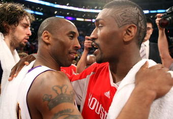 LOS ANGELES, CA - MAY 17:  Kobe Bryant #24 of the Los Angeles Lakers hugs Ron Artest #96 of the Houston Rockets after the Lakers defeated the Rockets 89-70 in Game Seven of the Western Conference Semifinals during the 2009 NBA Playoffs at Staples Center on May 17, 2009 in Los Angeles, California. NOTE TO USER: User expressly acknowledges and agrees that, by downloading and or using this photograph, User is consenting to the terms and conditions of the Getty Images License Agreement.  (Photo by Stephen Dunn/Getty Images)