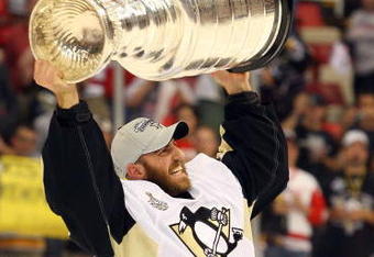 DETROIT - JUNE 12:  Goaltender Mathieu Garon #32 of the Pittsburgh Penguins celebrates with the Stanley Cup after defeating the Detroit Red Wings by a score of 2-1 to win Game Seven and the 2009 NHL Stanley Cup Finals at Joe Louis Arena on June 12, 2009 in Detroit, Michigan.  (Photo by Jim McIsaac/Getty Images)