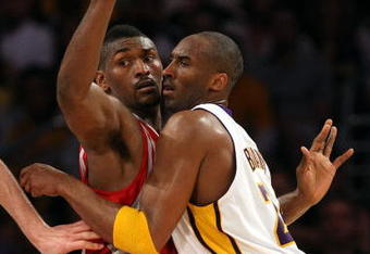 LOS ANGELES, CA - MAY 17:  Kobe Bryant #24 of the Los Angeles Lakers is covered by Ron Artest #96 of the Houston Rockets in the third quarter of Game Seven of the Western Conference Semifinals during the 2009 NBA Playoffs at Staples Center on May 17, 2009 in Los Angeles, California. NOTE TO USER: User expressly acknowledges and agrees that, by downloading and or using this photograph, User is consenting to the terms and conditions of the Getty Images License Agreement.  (Photo by Stephen Dunn/Getty Images)