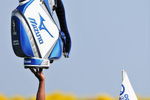 PARIS - JUNE 30:  Caddie Hugo Benson holds a Mizuno golf bag with one hand whilst tending the flag for his player during practice prior to the Open de France ALSTOM at the Le Golf National Golf Club on June 30, 2009 in Versailles, France.  (Photo by Stuart Franklin/Getty Images)